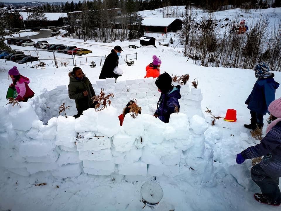 Students build a snow fort outside